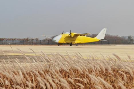 Yellow and white aircraft on airfield.