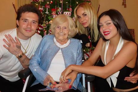 Family photo with an elderly woman sitting in a wheelchair.