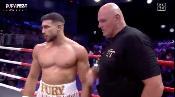 Boxer and trainer in boxing ring.