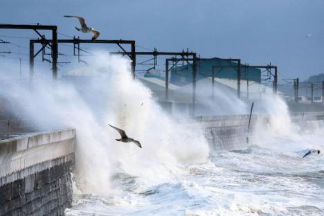 High waves crashing over a seawall during a storm.
