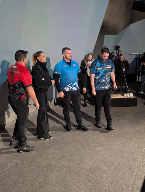 Four people standing in an indoor setting.