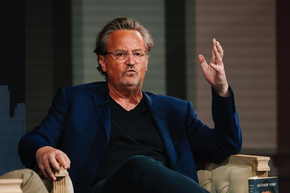 Matthew Perry speaking at a book event.