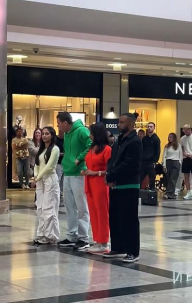 Shoppers watching a Towie star joining a conga line and dancing through a busy mall.