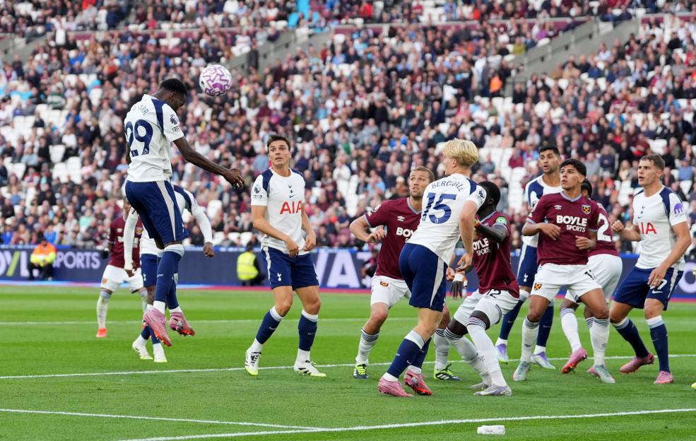 Pape Matar Sarr scoring a header during a Premier League soccer match.