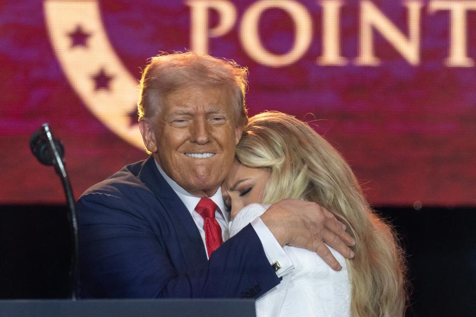 U.S. President Donald Trump embraces Erika Kirk at a memorial service.