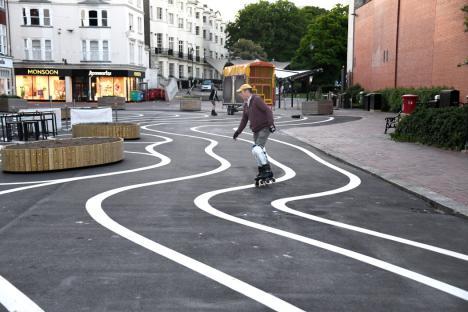 A newly pedestrianised zone has been branded a waste of money with a silly design at a huge cost to the taxpayer along Montague Place in Worthing, West Sussex. Wiggly white lines were added to the new tarmac surface which has cost ¿178,000 as part of an improvement scheme, of which ¿23,500 was spent on design and management fees and ¿1,230 on the painting of the swirly white lines. The Worthing Society Committee were dismayed to see the appearance of the 'swirly' white lines and urged the council to remove the harsh, intrusive white lines as soon as practically possible. Writing on Facebook Sue Belton Worthing Society Chair added, 'This area is part of the historic South Street Conservation Area and should showcase the town linking Montague Street to the seafront promenade. In our opinion these extensive white lines are over-dominant. They detract from the historic character of the listed buildings' Previously the road was used as parking for the disabled for a very short walk to the shops. Now tarmacked, the area has allowed cafe's and restaurants to have more outdoor seating, along with new wooden planters which are yet to have flowers and shrubs planted. People took to Facebook to give their views, Tamara Murray wrote 'Huge shame, waste of money and silly design. By taking away the safe disabled parking there it will take away business from Worthing.' Andrea Bristow added, 'It looks like a kid has been let loose with a white line machine! What an absolute mess.' 'Looks tacky and a terrible waste of money' wrote another mystified resident. Roy Hammond saw the funny side writing, 'I think this is very thoughtful of the council. It's an effort towards all the drunks in Worthing to make them think they are walking in straight lines.' Following a freedom of information request to Adur & Worthing Council, they responded with the costings, 'The pedestrianisation of Montague Place has cost ¿178,000, of which ¿23,500 was full technical scheme design and management fees. This was fully funded by the high street grants provided by the government to the Borough Council in response to the re-opening of the high street following the lifting of restrictions. The costs of the decorative white lining were ¿1,230, which included the cost of material and installation. These costs are included in the overall cost envelope above.' Please credit: Paul Jacobs/pictureexclusive.com Standard reproduction rates apply, contact Paul Jacobs, Picture Exclusive to arrange payment - 07923 866166, pictureexclusive@gmail.com