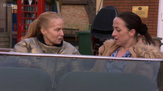 Two women talking in a car.