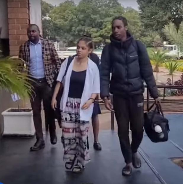 Two young British women escorted by officials after being arrested for drug smuggling.