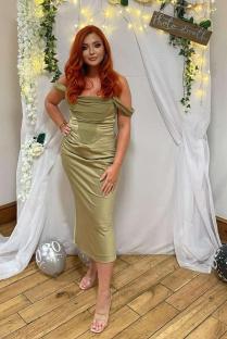 Woman in olive green dress at a photo booth.