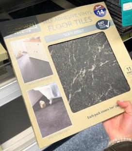 Box of Kingmann Premium self-adhesive vinyl floor tiles with slate effect.