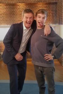 Travis Simpkins and another man posing together.