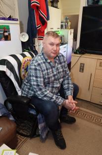 Man sitting on couch, giant rats stole his pizza.