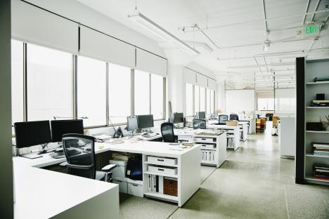 Empty office with multiple desks and computers.