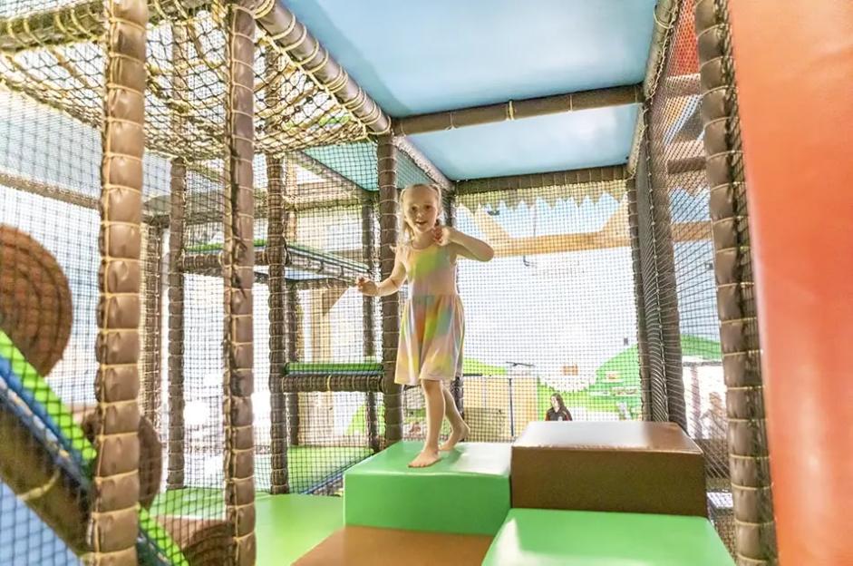 Girl playing in a soft play area.