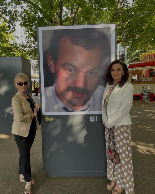 Shirley Ballas and her mother stand next to a large portrait of Shirley's late brother, David.
