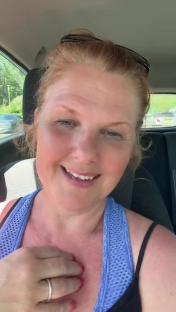 Woman in a car talking about selling used items.