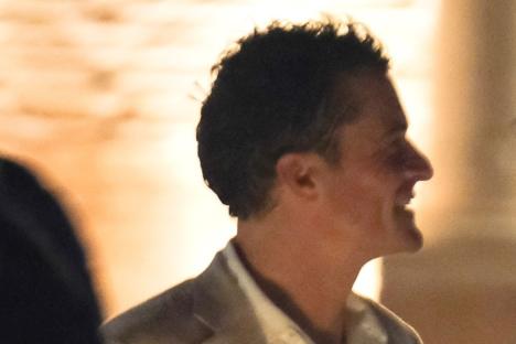 Newly single Orlando Bloom wraps his arm around mystery woman at Jeff Bezos’ wedding celebrations