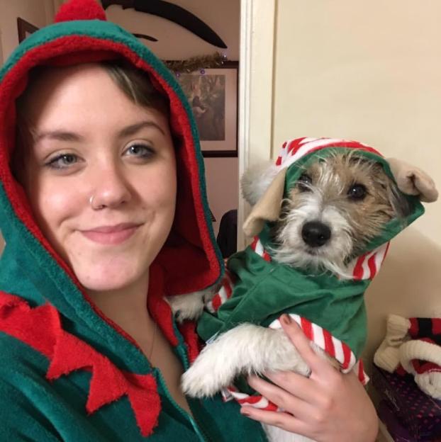 Woman and dog in elf costumes.