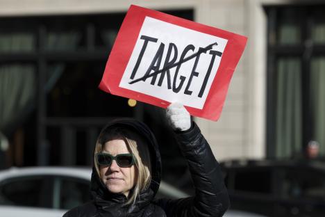 Woman holding a sign that says