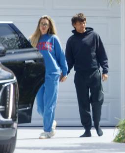 Louis Tomlinson and Zara McDermott holding hands.