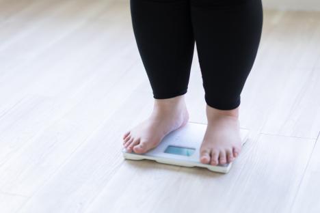 Woman's feet on a weight scale.