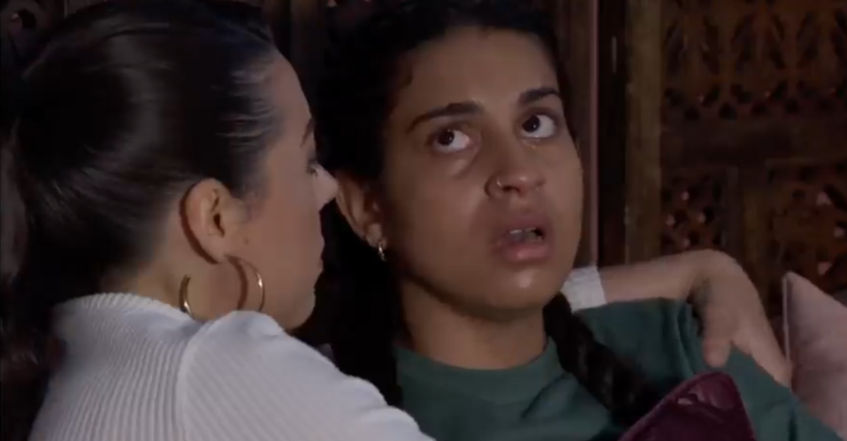Two women comforting each other.