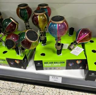 Solar-powered hot air balloon stake lights on display.