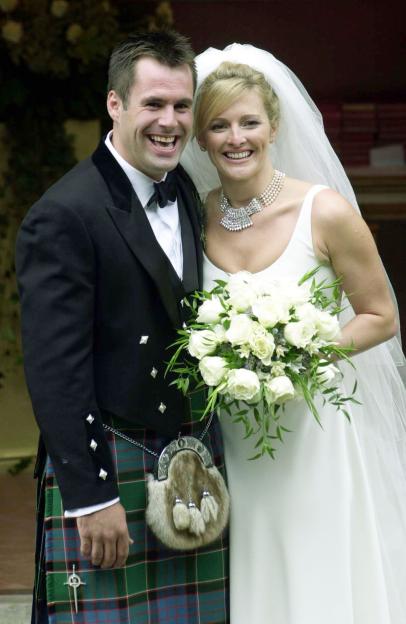 Rugby player Kenny Logan and sports television presenter Gabby Yorath smiling at their wedding.