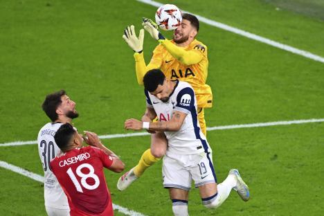 Tottenham's goalkeeper Guglielmo Vicario attempting a save.