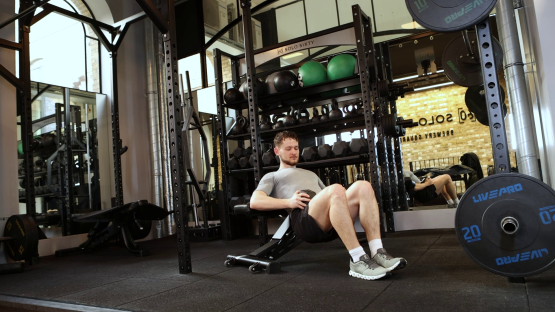 Man performing hip thrusts in a gym.