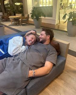 Couple cuddling on a couch.