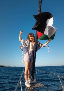 Greta Thunberg on a boat with a Palestinian flag.