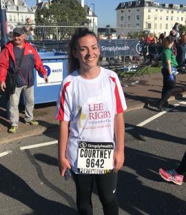 Courtney Rigby, wearing a Lee Rigby Foundation race shirt and bib, at a race.