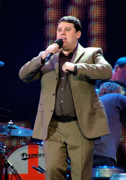 Peter Kay performing live on stage.