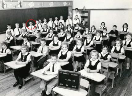 Black and white photo of Robert Prevost, the newly elected Pope, as a young boy in a classroom.