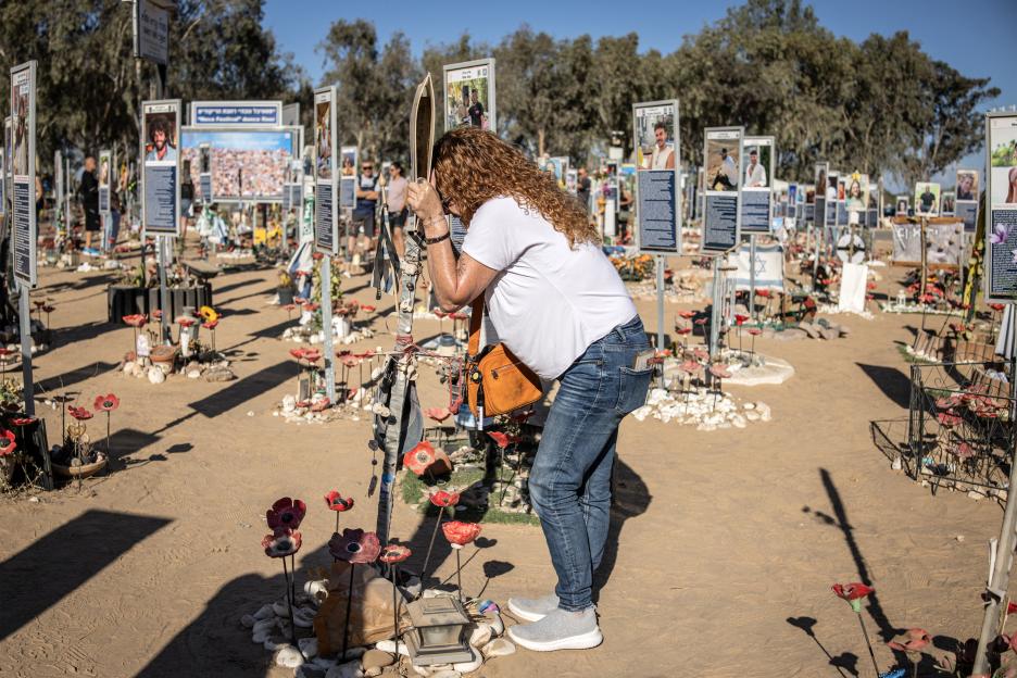 A woman reacts at a memorial for victims of the 2023 October 7 attacks at the Nova Festival grounds in Reim, southern Israel.