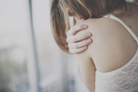 Woman hugging herself.