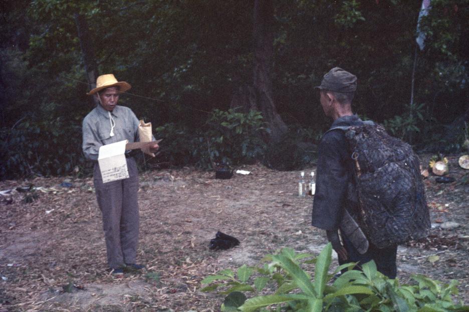 Lieutenant Onoda surrendering to a Japanese officer in the Philippines.