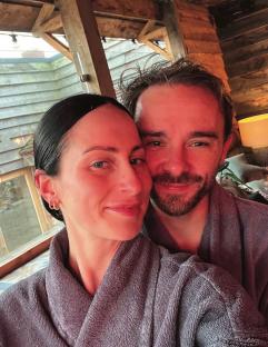 Couple in bathrobes taking a selfie.