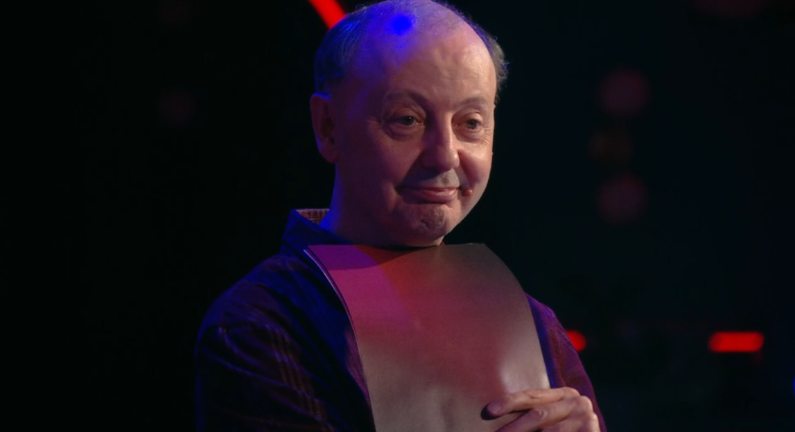 A man holding a rectangular object.