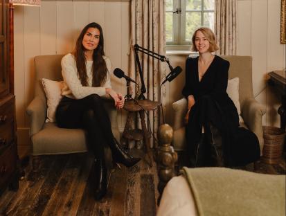 Two women sitting in armchairs, participating in a podcast recording.