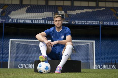 Liam Delap, Chelsea FC new signing, sits with a soccer ball at Stamford Bridge.