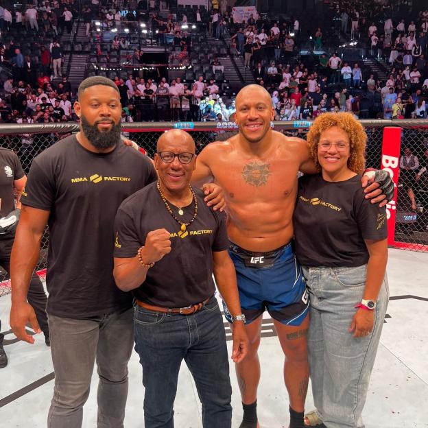 Ciryl Gane with his wife Julie and two other individuals at a UFC event.