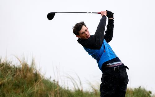 Golfer teeing off.
