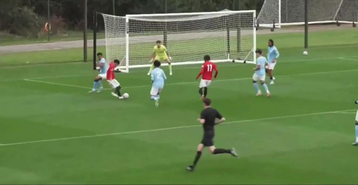 JJ Gabriel in a red Manchester United uniform scores a goal against Manchester City U18s.