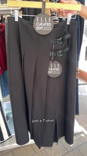 Black skirt with buckles and Elle Curated Edit 2025 tag.