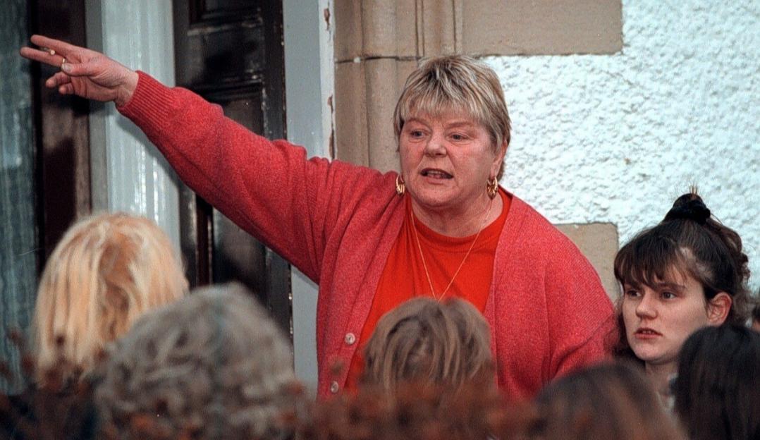 Margaret Hainey protesting outside the home of a convicted pedophile.