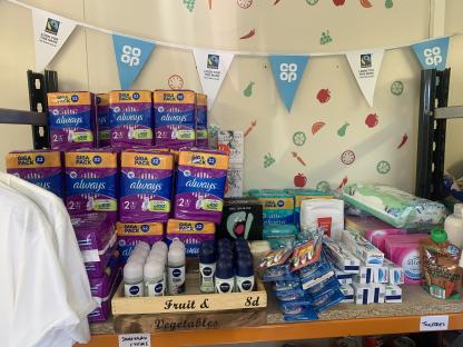 Shelf of sanitary products, toiletries, and deodorants.