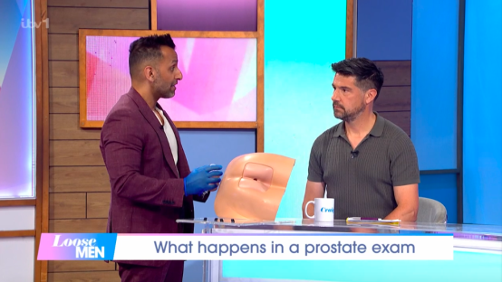 A doctor demonstrates a prostate exam on a model on the Loose Men TV show.