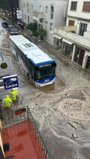 Bus submerged in floodwaters.